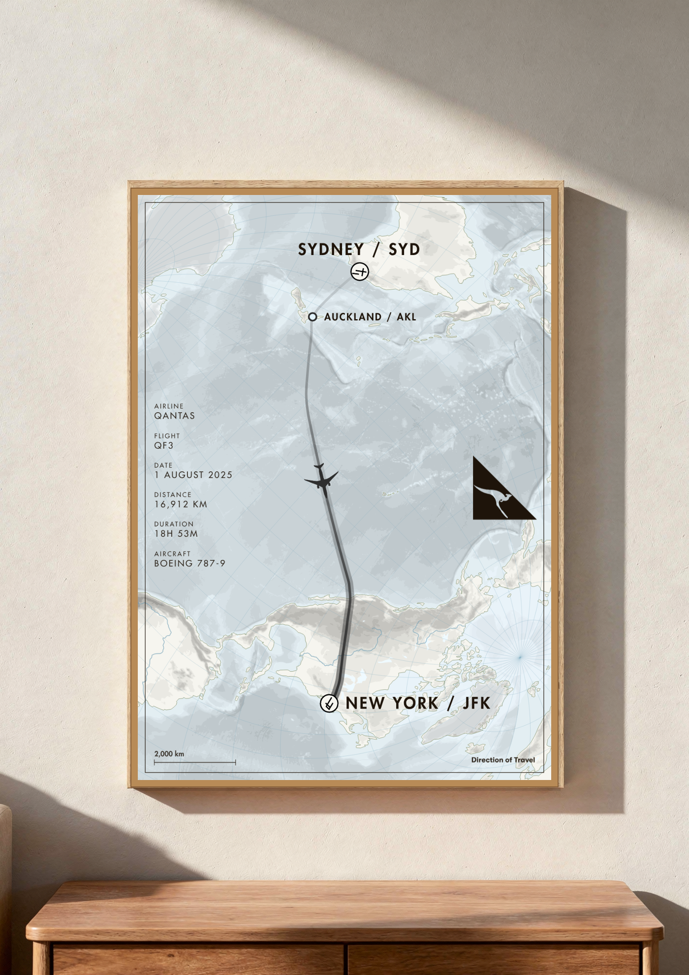 Sydney to New York via AKL A2 poster in a wooden frame in a room (AI-generated)